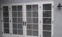 WoodClad or Ultra outswing doors with SDL grids.  Hardware color is bronzed anodized.